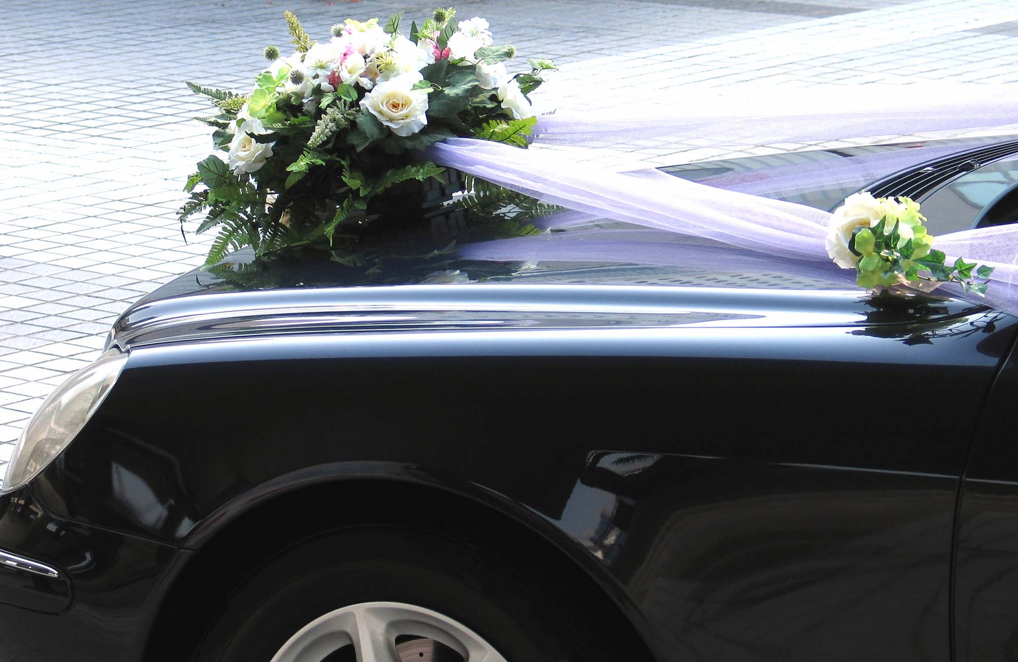 Car wedding decoration. Part of a black decorated car for a wedding ceremony
